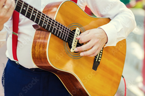 Practicing in playing guitar. Handsome young men playing guitar,Closeup of blurry male hands playing the guitar,music concept