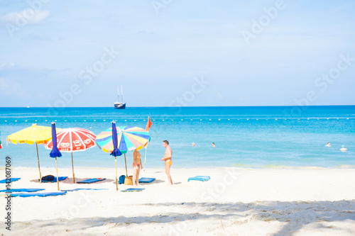 Fototapeta Naklejka Na Ścianę i Meble -  Sea beach with people relaxation and colorful of umbrella