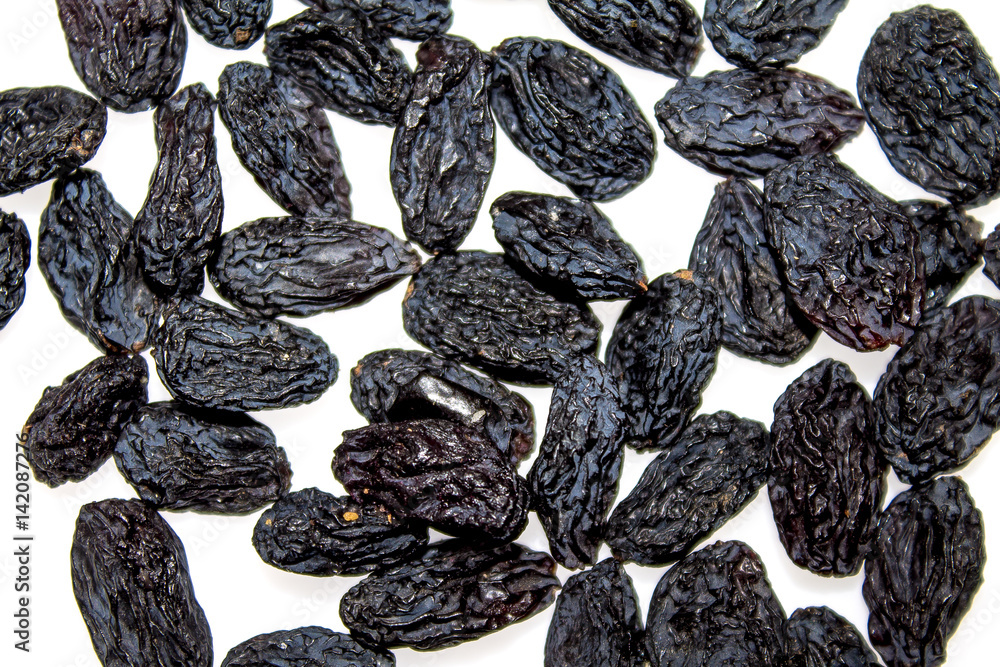 Dried black grapes on a white background Dried black grapes on a white background