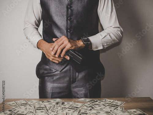 Money and power, Senior gangster with gun, in suit at the table.
