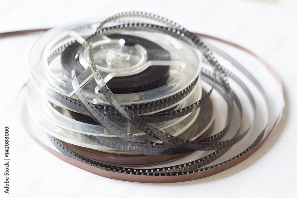 Naklejka premium Old reels with black and white film and magnetic tape