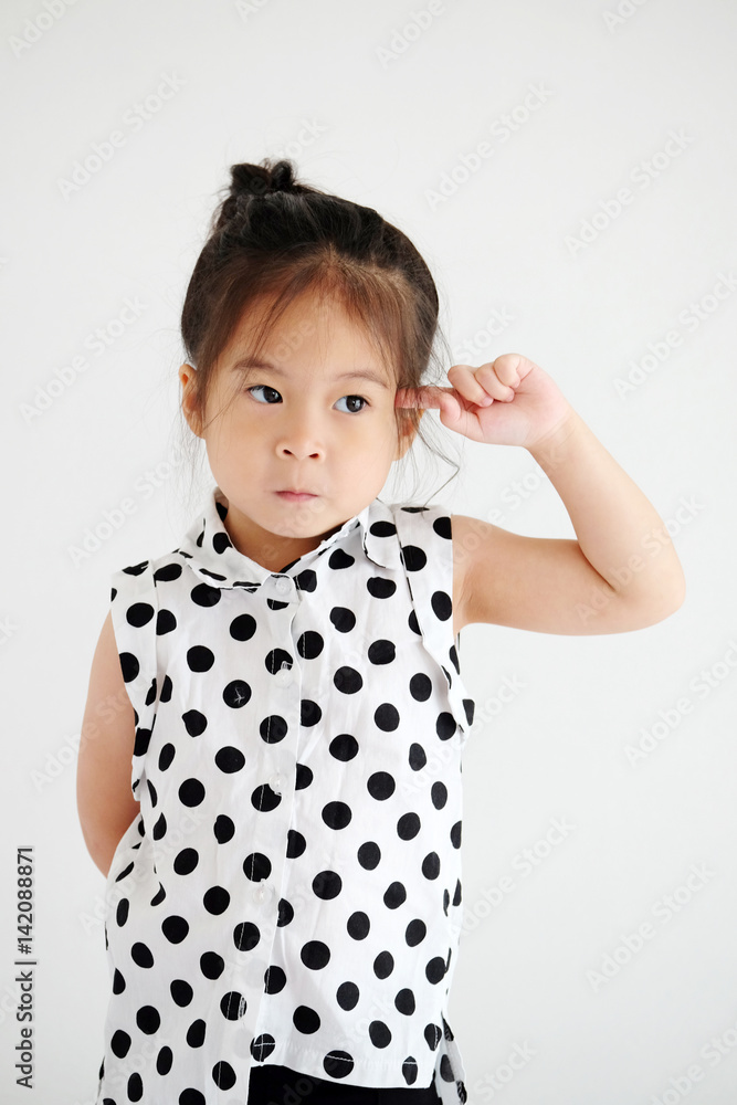 Cute little asian girl with thinking posture in white bedroom background Cute little asian girl with thinking posture in white bedroom background