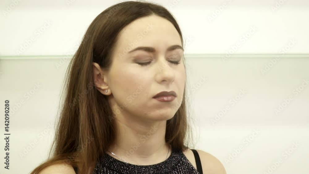 Beautician is applying spray to woman's face, slow motion Beautician is applying spray to woman's face, slow motion