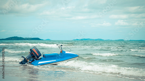 Beach and sea with blue sky and water scooter boat