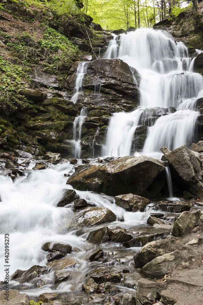 Waterfall in the mountains. Early spring in the Carpathians Ukraine. Travel. Waterfall in the mountains. Early spring in the Carpathians Ukraine. Travel.