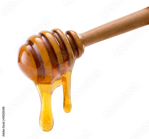 Fototapet honey dripping isolated on a white background