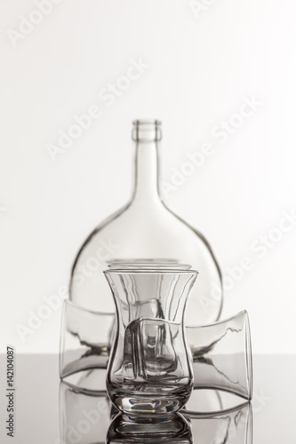 Empty transparent bottle and glass