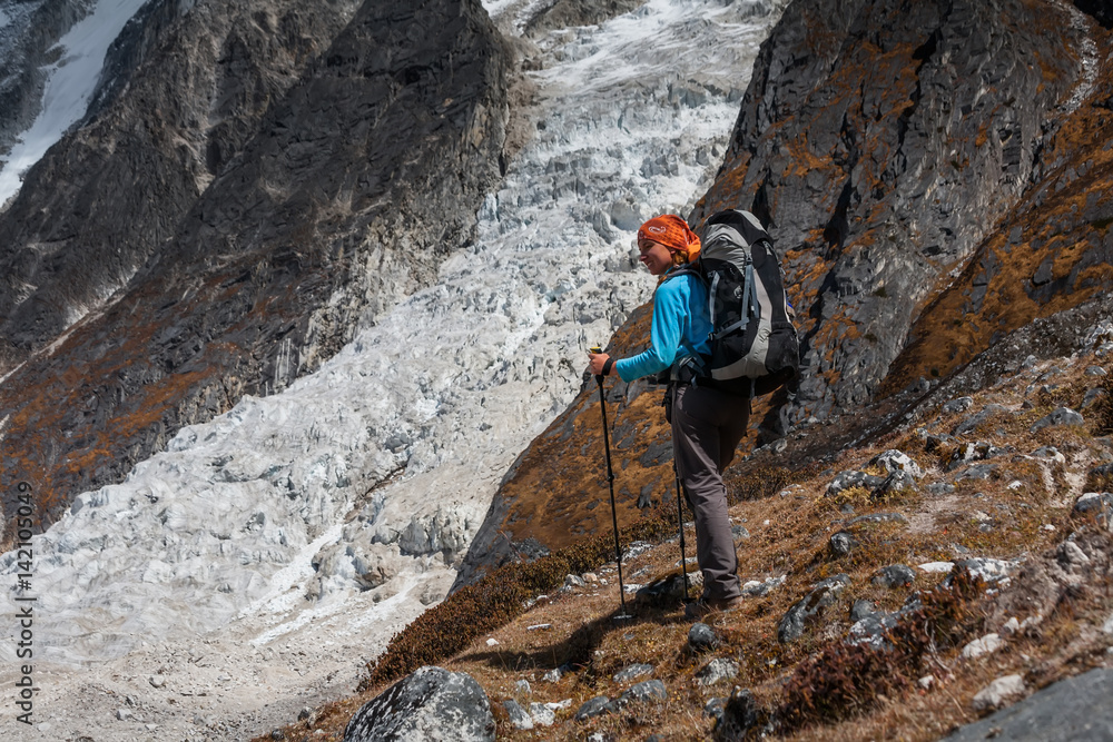 Trekker goes down fron Larke La pass on Manaslu circuit trek in Nepal