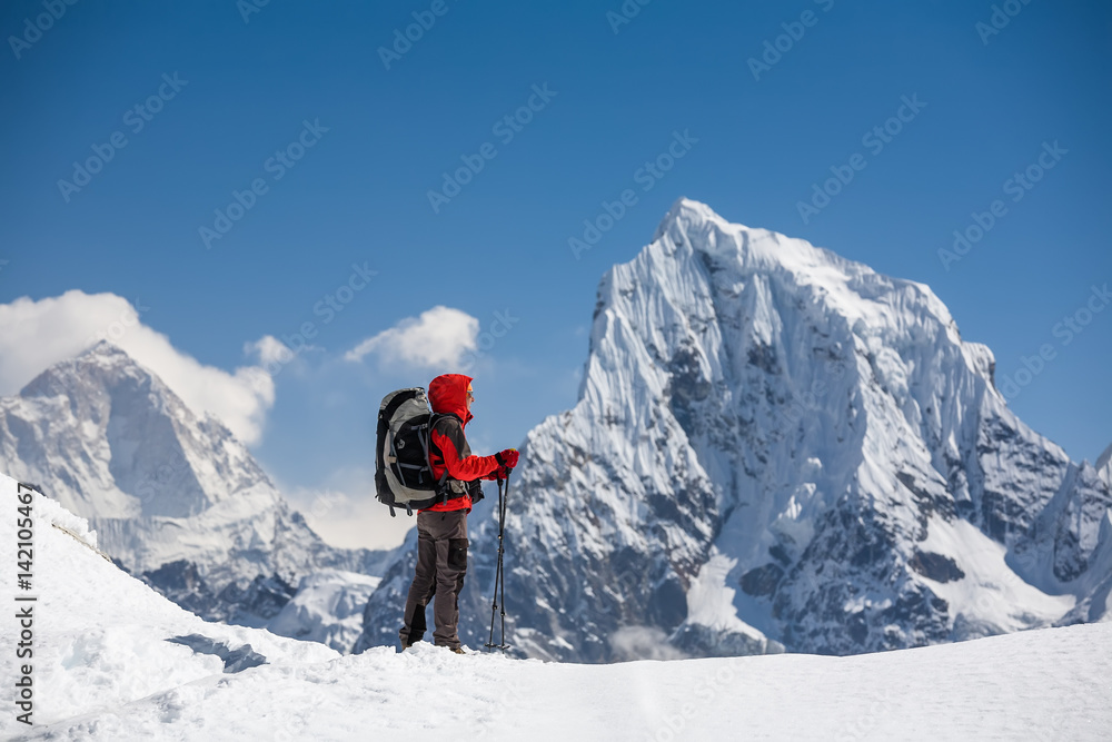 Trekker is walking by Renjo La pass in Everest region Trekker is walking by Renjo La pass in Everest region