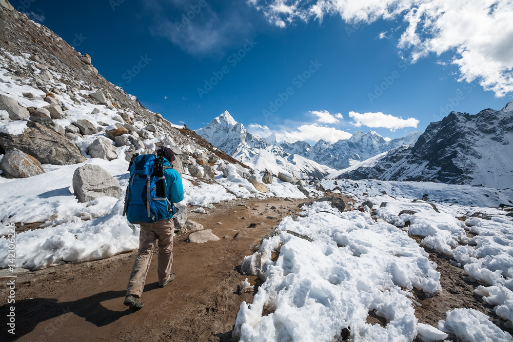 Trekker approaching Amadablan mount in Khumbu valley on a way to Namche Bazar
