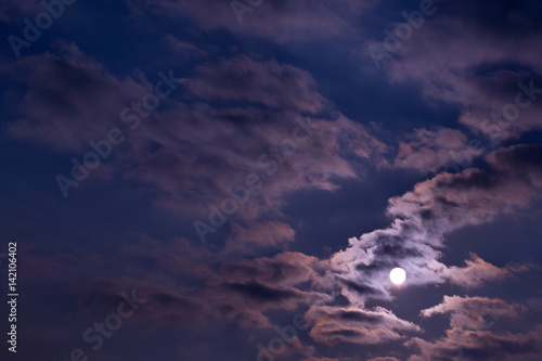 Dramatic night sky with clouds and bright full moon