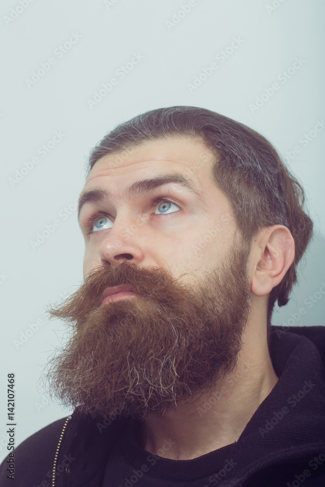 Obraz premium bearded surprised brutal caucasian man look up