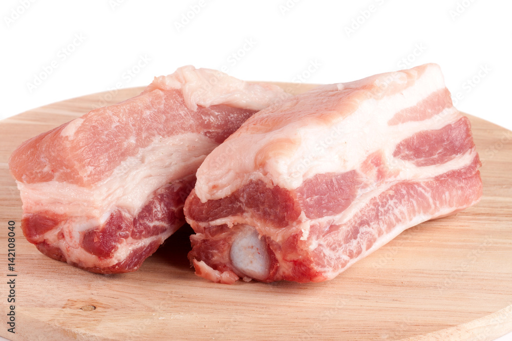 pieces of pork on a cutting board isolated on white background