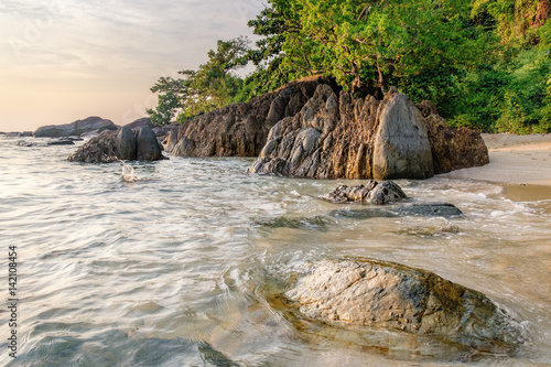 Beautiful seascape. Sea and rock at the sunset. Nature composition. Thai White Sand Beach in sunset time in Koh Chang island, Thailand.