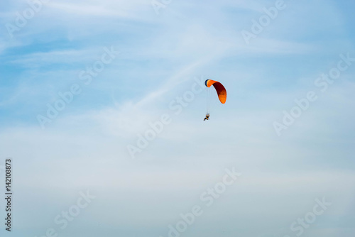 man ride Paramotor flying in the sky
