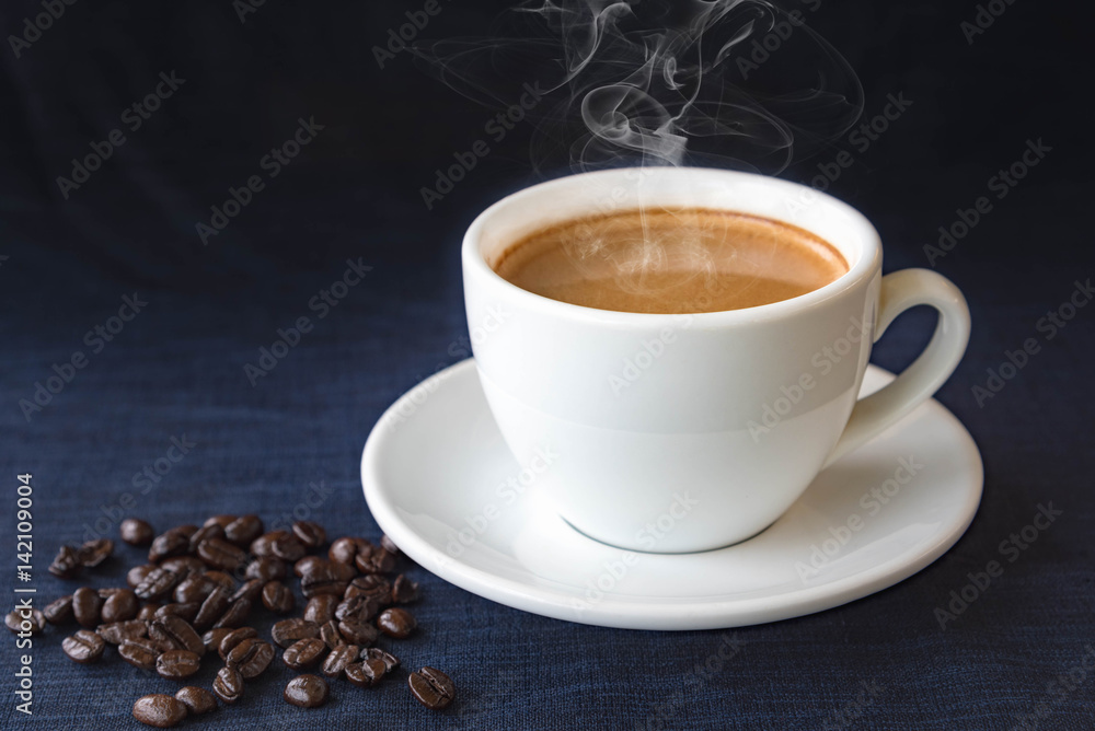 Coffee cup and beans on a dark background Coffee cup and beans on a dark background