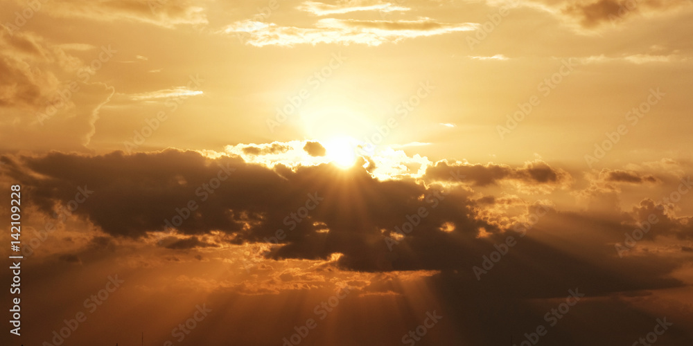 Bright sun with beams and the dark clouds
