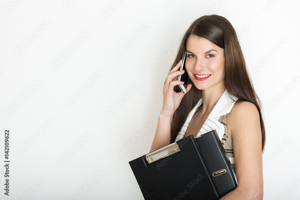 Portrait of a positive business woman talking on a phone against white background Portrait of a positive business woman talking on a phone against white background