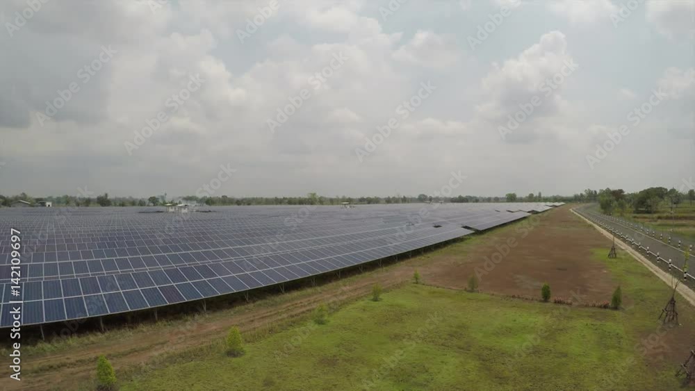 Solar farm - Aerial view of large farm of solar panels producing solar electricity. Alternative sustainable energy from solar energy concept Solar farm - Aerial view of large farm of solar panels producing solar electricity. Alternative sustainable energy from solar energy concept