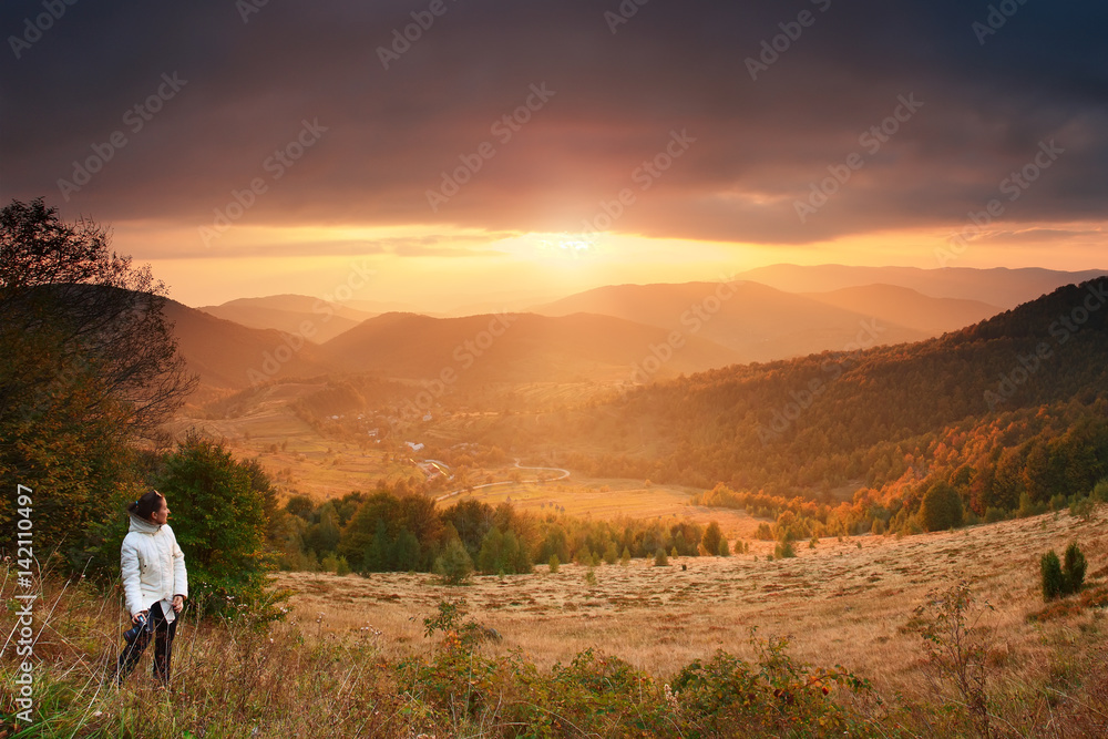 Traveler at mountain sunset background