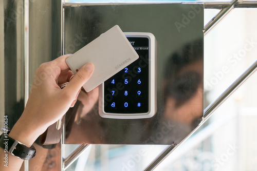 a girl use keycard to access apartment
