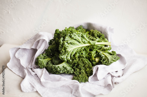 Close up of kale leaves. Green vegetables leafy on light table. 