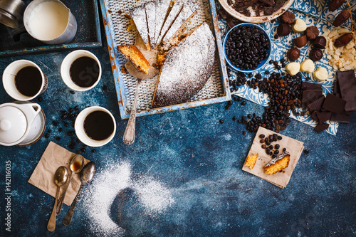 Tarta de santiago, spanish almond cake with coffee and chocolate bonbon over party table