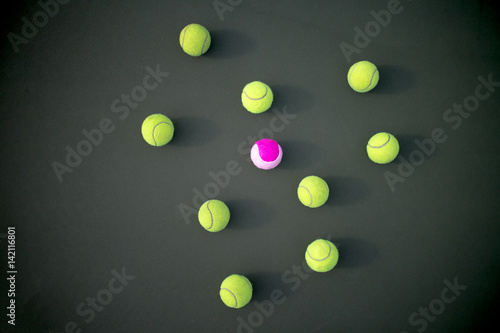 Pink tennis ball among greens © icedmocha