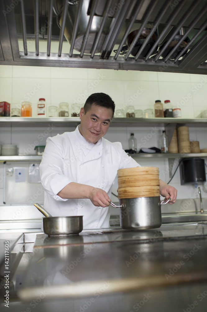 Portrait of the Chinese cook in the kitchen Portrait of the Chinese cook in the kitchen