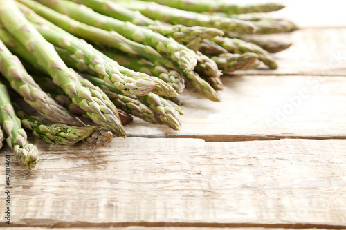 Green asparagus on grey wooden table