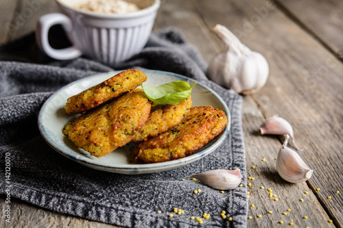 Fried millet patties with oatmeal, carrot, egg, garlic and onion