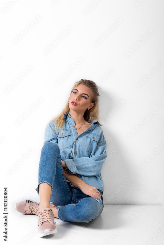 Beautiful girl sits and smiles blonde blue eyes Beautiful girl sits and smiles blonde blue eyes
