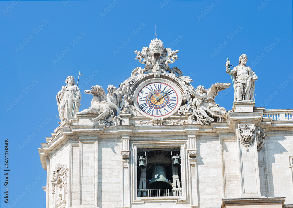 Sculptures and clock on the facade of Vatican city works. Vatican. Rome. Italy.