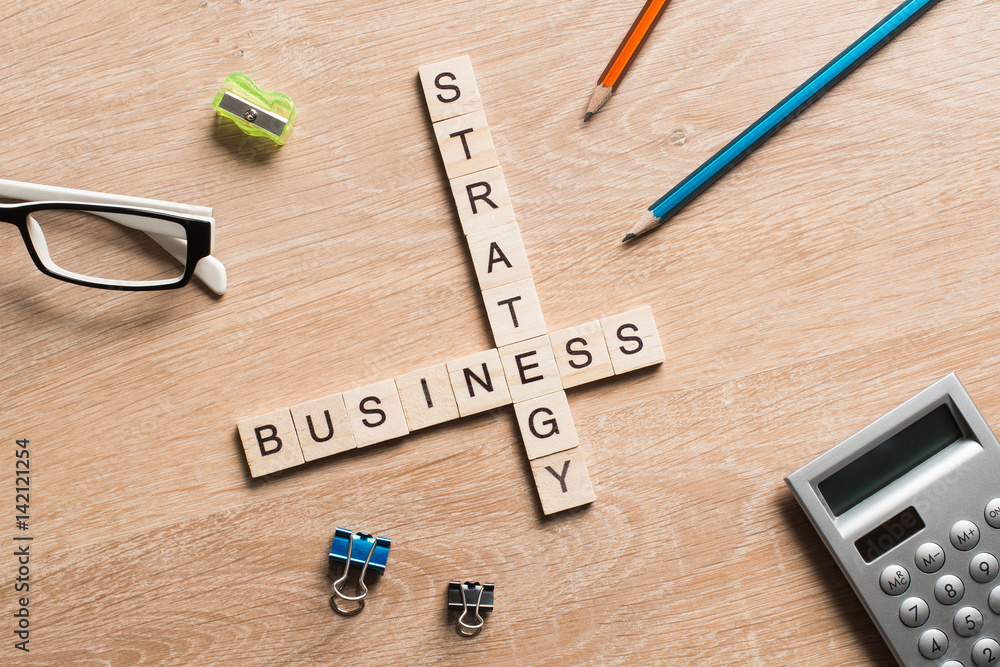 Conceptual business keywords on table with elements of game making crossword Conceptual business keywords on table with elements of game making crossword