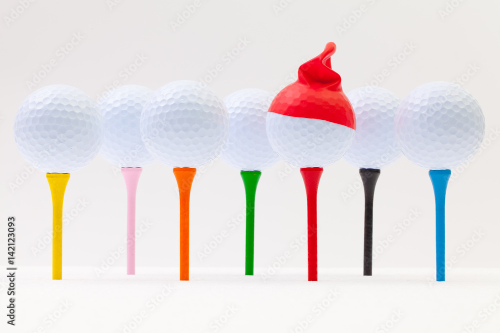 White golf balls with funny cap. Funny golf concept. White golf balls with funny cap. Funny golf concept.