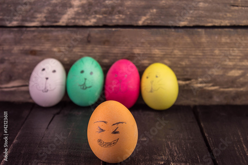 Laughing easter eggs on wooden planks . Happy Easter