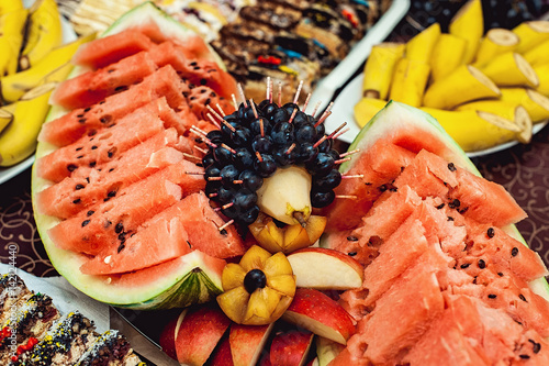 sliced watermelon and malon on a wooden table photo