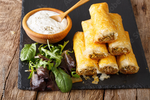 Crispy rolls borek with minced meat and eggs close-up on the table. horizontal photo