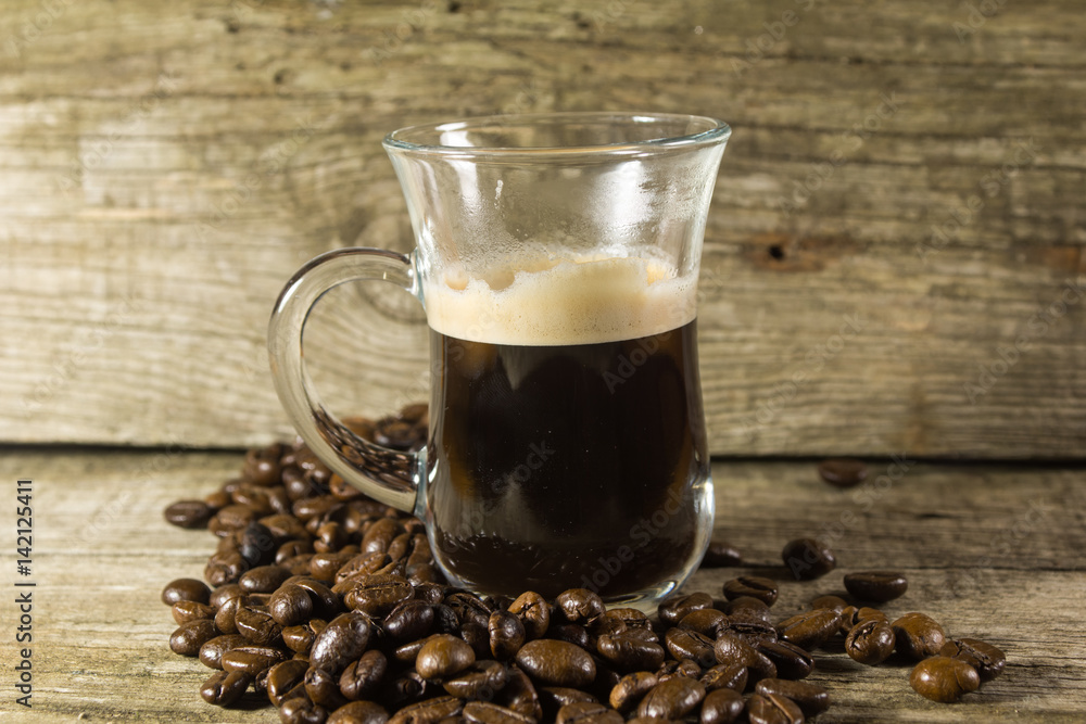 Cup and grain of coffee over wooden background Cup and grain of coffee over wooden background