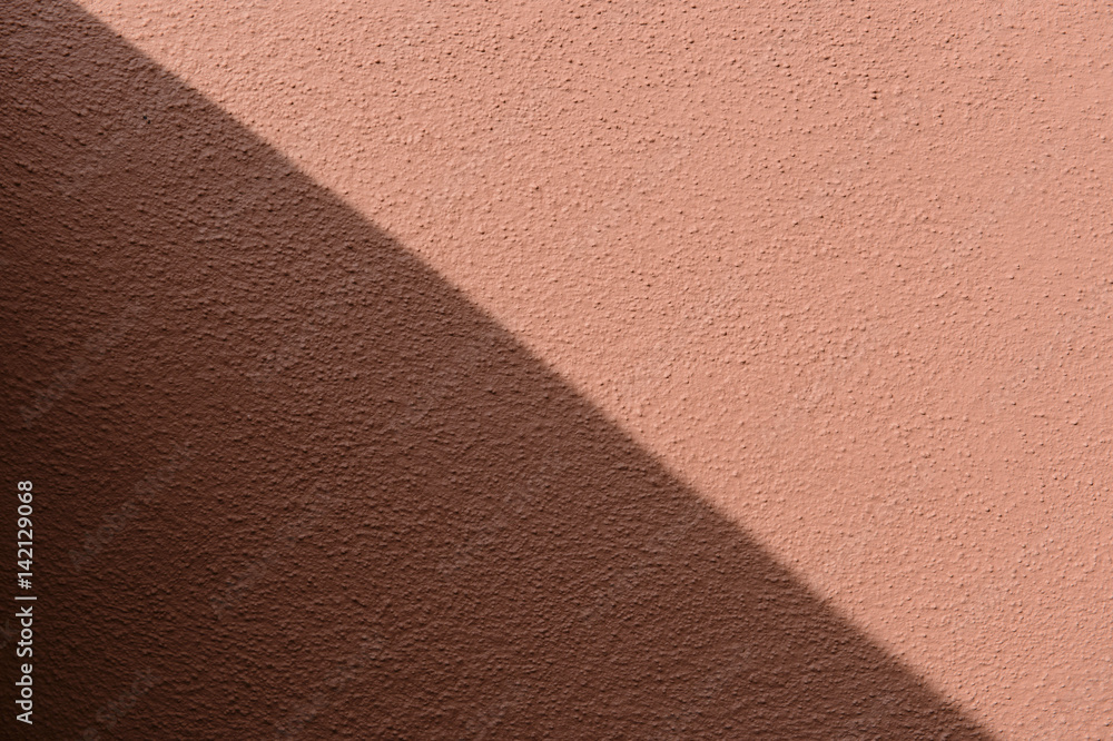 Fototapeta premium shadow and sunlight on a red wall background, diagonally splited