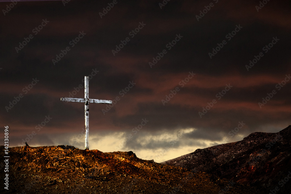 A Beginning: Single cross on a lone hill, with a threatening looking storm in the background. Ideal for seasonal advertising, poster, or greetings card applications.