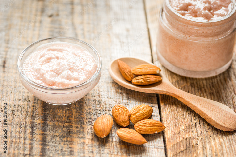natural scrub with almond on wooden table background natural scrub with almond on wooden table background
