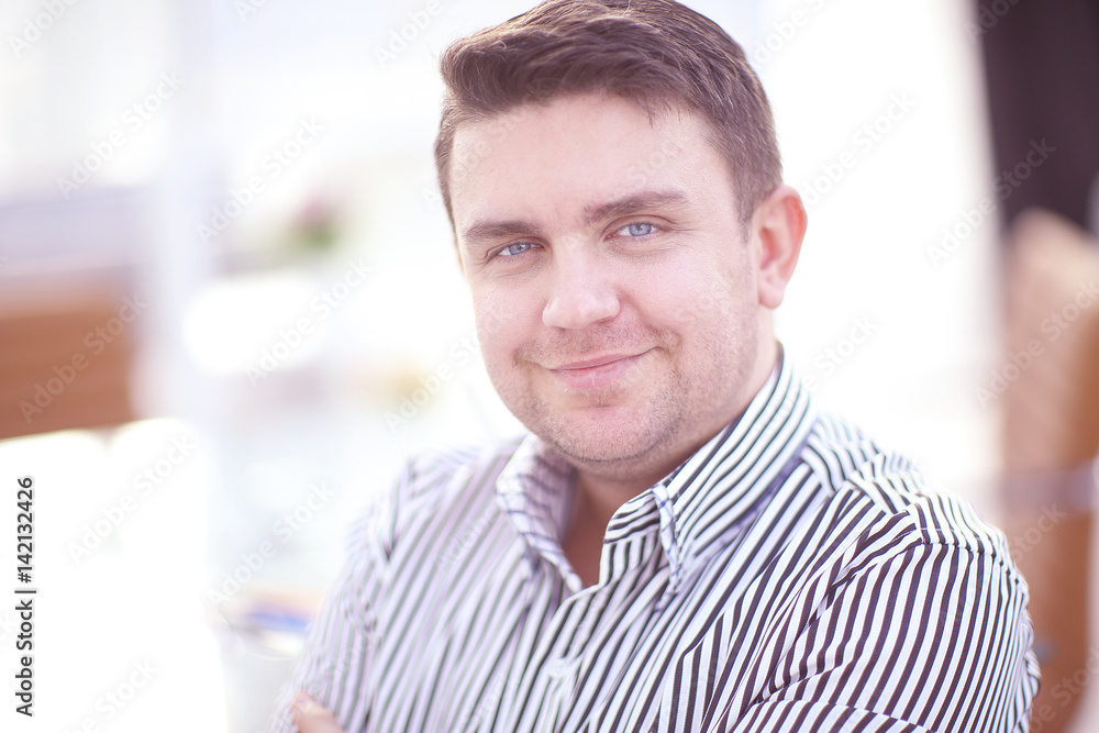 Successful businessman posing and smiling at camera Successful businessman posing and smiling at camera