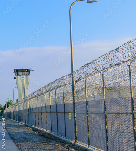 Walk along prison fence lin