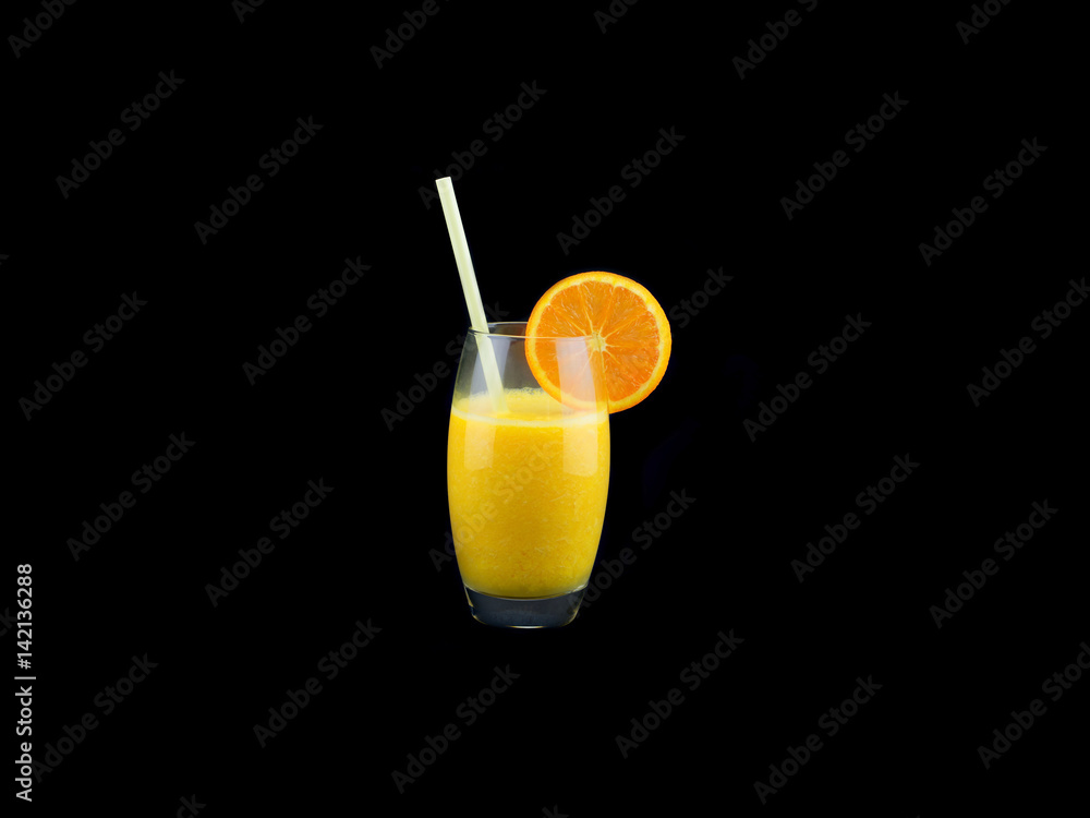 A glass with fresh orange juice isolated on black background A glass with fresh orange juice isolated on black background