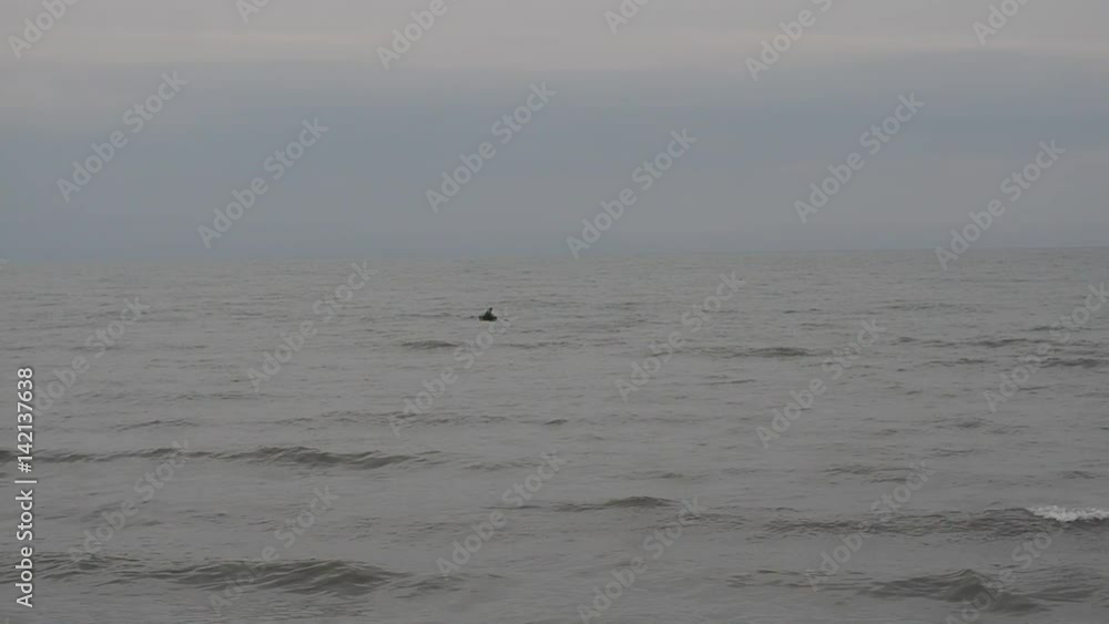Fisherman in boat trying to fishing in Caspian Sea in stormy weather. Absheron Novkhani Azerbaijan Fisherman in boat trying to fishing in Caspian Sea in stormy weather. Absheron Novkhani Azerbaijan
