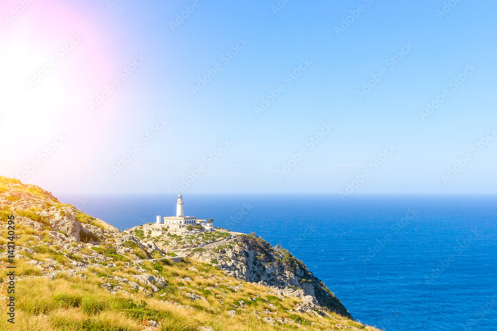 Lighthouse at Cape Formentor near rocks for print
