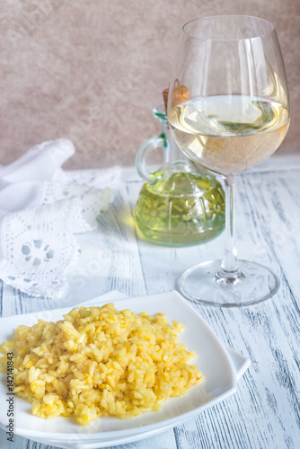 Portion of risotto with glass of white wine
