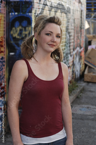 Smiling Teenage Girl Pretty in Alley with Graffiti