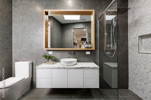 Modern designer bathroom with herringbone shower tiling